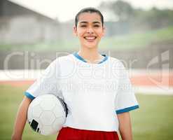 Im ready to kick it. Cropped portrait of an attractive young female footballer standing outside with a soccer ball in hand.