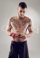 Preparing for the big fight. Shot of an MMA fighter in the studio.