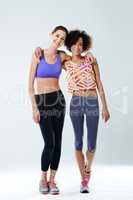 Fitness besties. Two beautiful young women smiling at the camera in sports clothing.