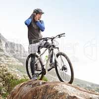 Trail readiness. A young mountain biker fastening his helmet.
