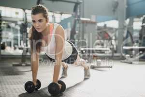 Be the girl who decided to go for it. Shot of a young woman working out with weights at the gym.