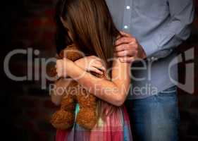 Innocence lost. Abused little girl with her abuser gripping her shoulder.