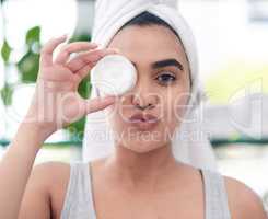 Moisturizing my way to flawless,glowing skin. Shot of young woman posing with facial moisturiser.