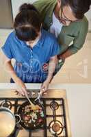 Cooking time is their bonding time too. High angle shot of a mature couple cooking together at home.