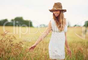 Theres a lot of beauty in ordinary things. Cropped shot of a young woman in a wheat field.