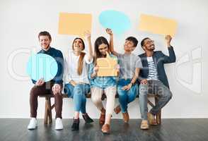 They are quite outspoken. Shot of a diverse group of creative employees holding up speech bubbles inside.