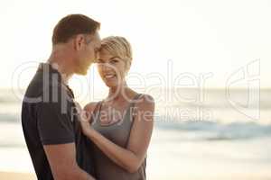 The sun shines on their love. Shot of a mature couple enjoying a day at the beach.