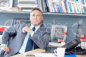 His experience is second to none. Portrait of a formidable business manager sitting at his desk - Copyspace.