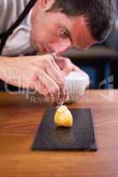 Hes an artist in the kitchen. A chef carefully preparing a gourmet meal.