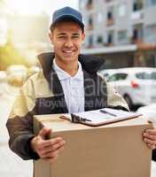 We deliver no matter what. Portrait of a courier carrying a package during a delivery.