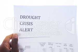 Time to save water. Closeup of an unrecognizable person holding a paper with a notification on it saying drought crisis alert.