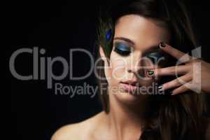 Her makeup is eye-catching. Shot of a beautiful young woman with her eyes closed and dramatic makeup.