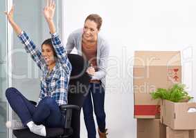 The excitement of moving is in the air. Shot of two female entrepreneurs moving into a new office.