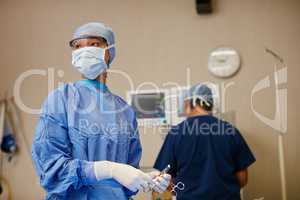 Shes got life saving experience. Shot of a surgeon ready to perform a surgery in an operating room.