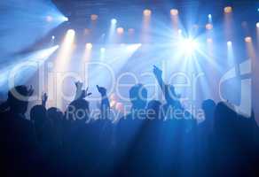 Cheering on their favourite band. Shot of adoring fans at a rock concert.