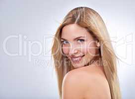 Blonde and beautiful. Studio portrait of a young woman with long blonde hair.