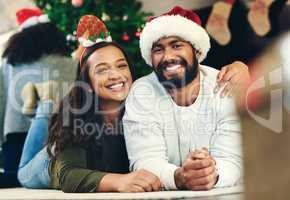 What a treasure to spend this time together. Portrait of a happy young family celebrating Christmas at home.