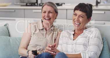 This film is hilarious mom. Shot of s mother and daughter enjoying a TV show together.