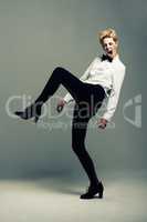 Rebel chic. Studio shot of an attractive young woman posing against a gray background.