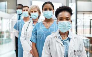 Quality and safety is number one in healthcare. Portrait of a group of medical practitioners wearing face masks while standing together in a hospital.