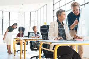 Constructive criticism is welcomed here. Shot of a group of creative designers hard at work in their modern office.