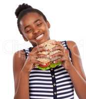 This a darn good sandwich. Shot of a happy young african american girl holding a salad sandwich isolated on white.