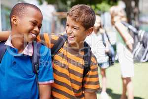 Forming lasting friendships at school. Two boys in their school playground having a good laugh together - copyspace.