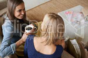 Coffee break between shopping. Two gorgeous friends enjoying some coffee while out shopping together.