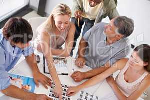 This is the idea-factory. A group of designers having a brainstorming session around a table.