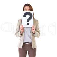 I have a question for you. Studio shot of a young businesswoman holding a placard with a question mark on it.