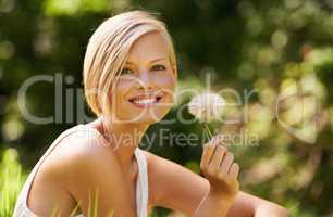 Fascinated by nature. Shot of an attractive young woman outdoors on a summer day.