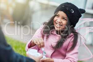 How nice of you to join me for tea. Shot of a cute little girl having a tea party outside.