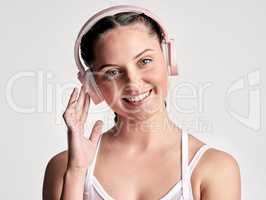 Listening to the music you like can enhance your performance. Studio portrait of a sporty young woman wearing headphones against a white background.