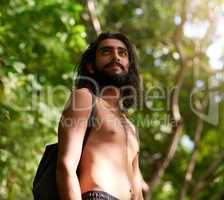 Survival - May the forest be with you. Shot of a handsome young man hiking through a forest area.