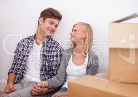 We took the leap and bought a house. Shot of a happy young couple on their moving-in day.