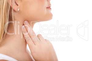 Monitoring her pulse rate carefully. Young woman taking her pulse rate against a white background.