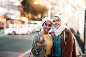 Friends that travel together, stay together. Cropped shot of two attractive young women wearing headscarves and standing together while touring the city together.