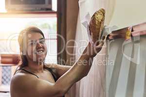 Our goods are top quality. Cropped shot of a young woman working in her bakery.