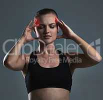 Ease your body into exercise to avoid pain. Studio shot of a sporty young woman.