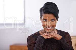 Taking on the days challenges with confidence. A portrait of a beautiful young woman sitting in an office.