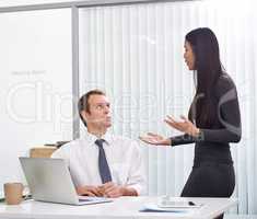 A difference in opinion. Shot of two colleagues discussing work in the office.