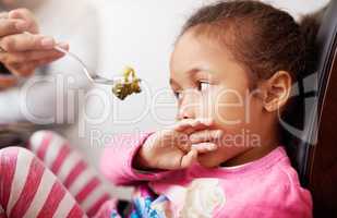 I really dont want to eat this. Shot of a little girl refusing to eat her food.