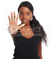 I have the power to say stop. Confident young African woman isolated on a white background and giving the stop gesture.