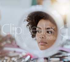 In the vanity. Cropped shot of a reflection of an attractive young woman while her makeup gets done.