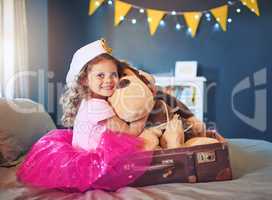 On the way to the land of make believe. Portrait of an adorable little girl dressed up as a sailor and playing on the bed at home.