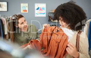 I think this would look lovely on you. Shot of a shop assistant helping a customer in a clothing store.