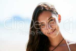 Freckles are fierce. Closeup shot of a beautiful young woman posing on the beach.