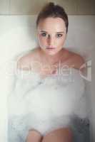 Time to unwind. Portrait of an attractive young woman relaxing in the bathtub.