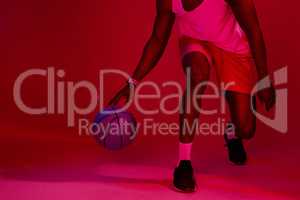 Own your position. Red filtered shot of an unrecognizable sportsman posing with a basketball in the studio.