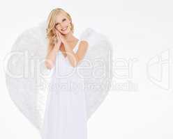 Ethereal beauty. Studio shot of a young woman in angel wings isolated on white.